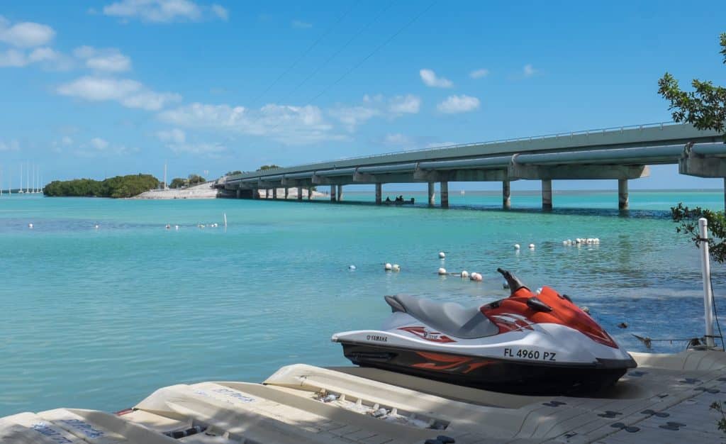 The overseas highway in the Florida Keys, on a bridge that crosses along the shallow turquoise water, connecting the islands.