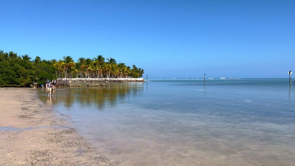 A super calm beach on an almost glassy bay.