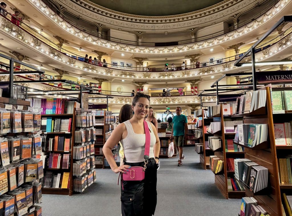 Kate standing in the middle of a grand, brightly lit bookstore.