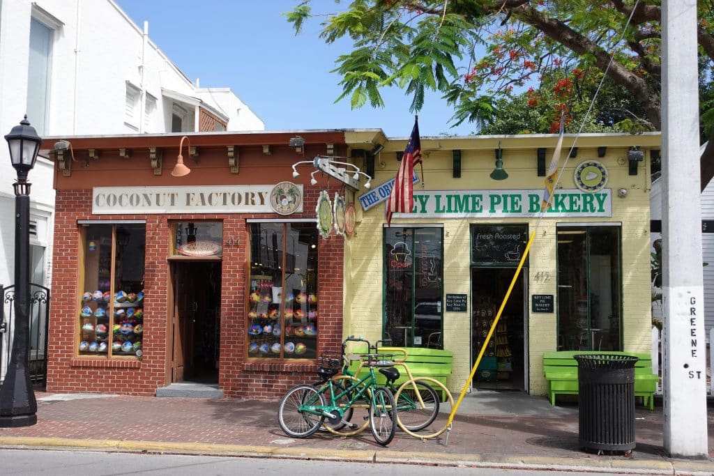 Two brick buildings side by side in Key West: the coconut factory and the lime-green key line pie bakery!