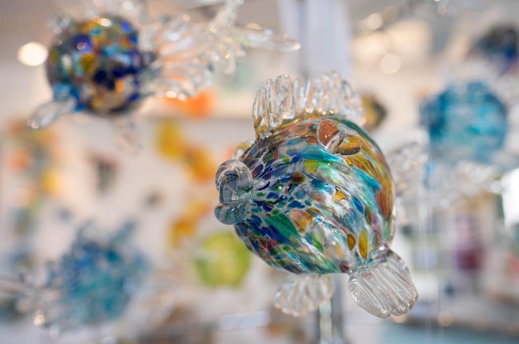 A colorful glass-blown fish in an art gallery.