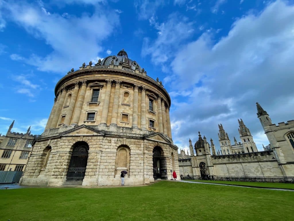 A round gothic building in Oxford, England, surrounded by green grass.