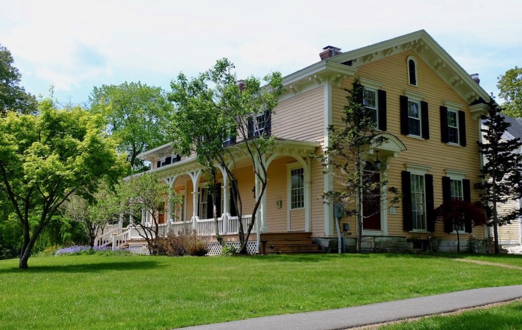 A pretty peach-colored house with a big porch.