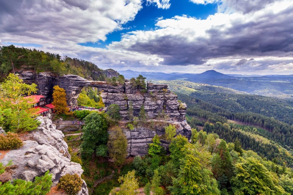 A national park with tall rock cliffs looking over a wild forested area.
