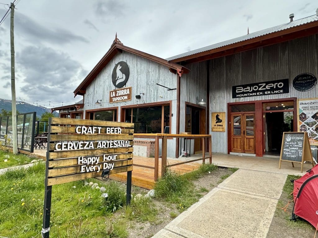 The entrance sign to a brewery, set in a big wooden building.
