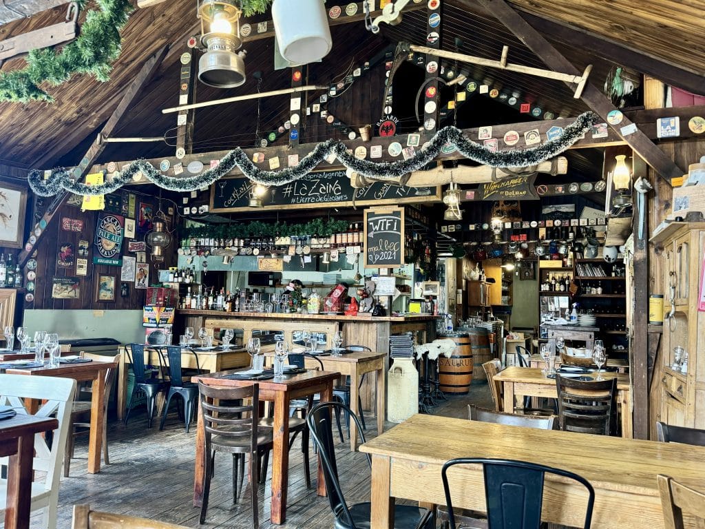 A cafe in Argentina filled with lots of garlands, beer coasters, and hanging decorations.