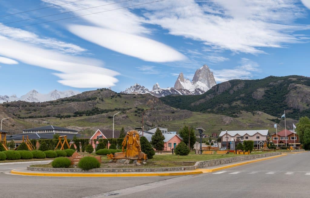 Colorful buildings in a small town, with a few mountains peeking out in the distance.