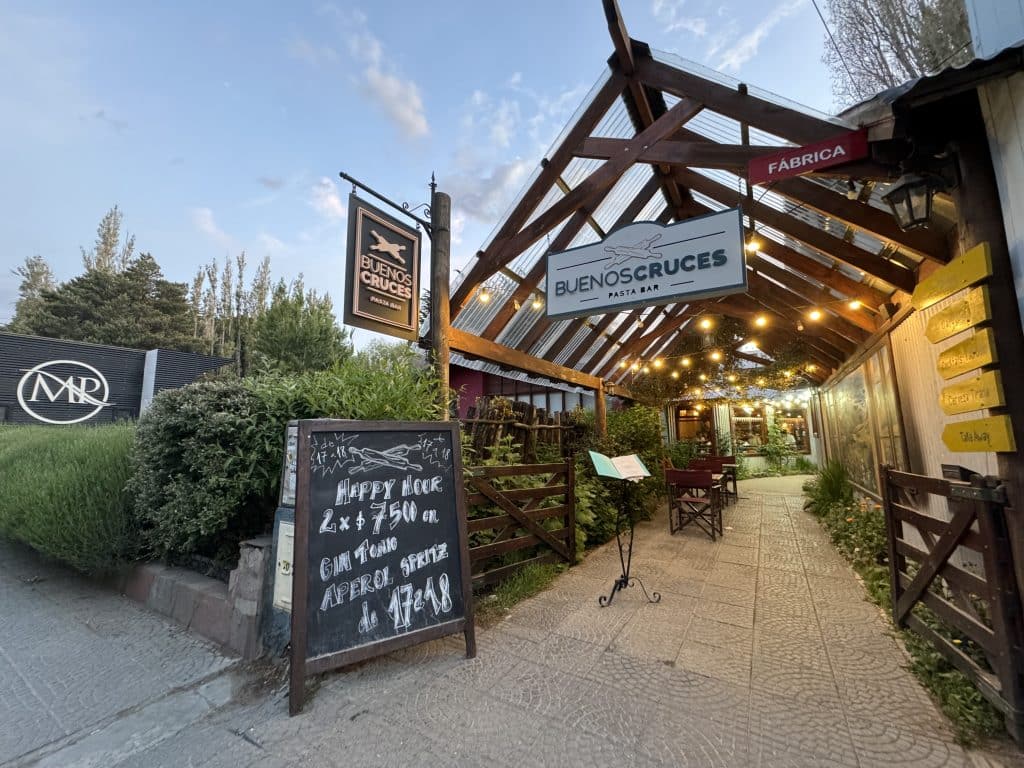 A restaurant with a big open wooden roof underneath an evening sky in El Calafate, Argentina.