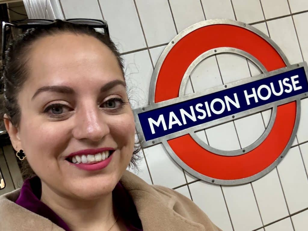 Kate taking a selfie next to the London Underground stop for Mansion House.