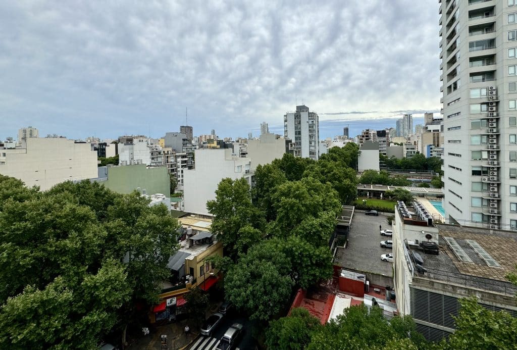 The view over Palermo, Buenos Aires, with skyscrapers and lush trees poking up around them.
