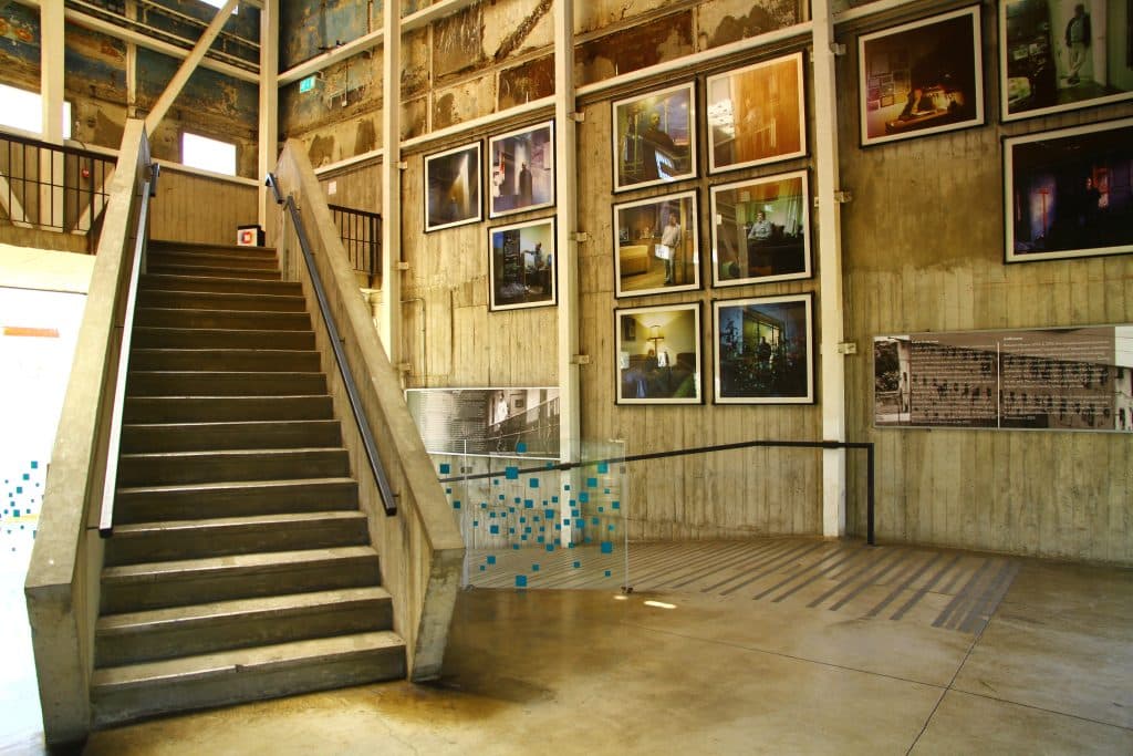 A cultural center with a big cement staircase and lots of photos on the walls.