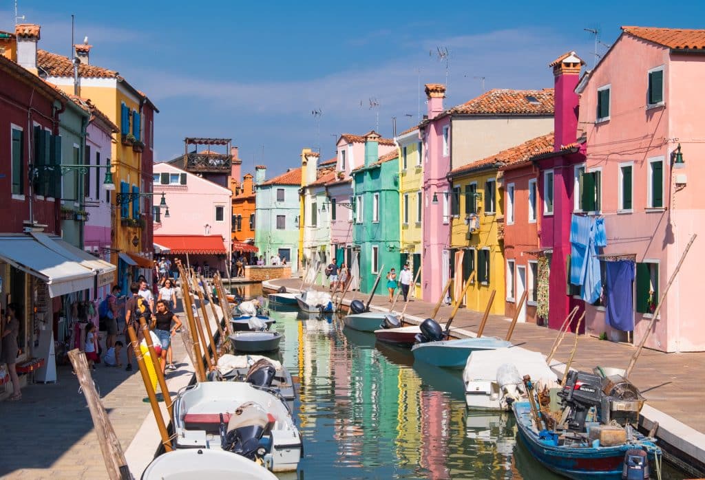 The almost neon, brightly colored buildings surrounding a canal on Burano Island in Venice.