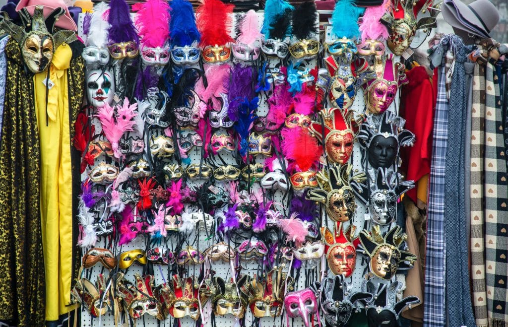 A store with rows and rows of colorful, feather-covered carnival masks.