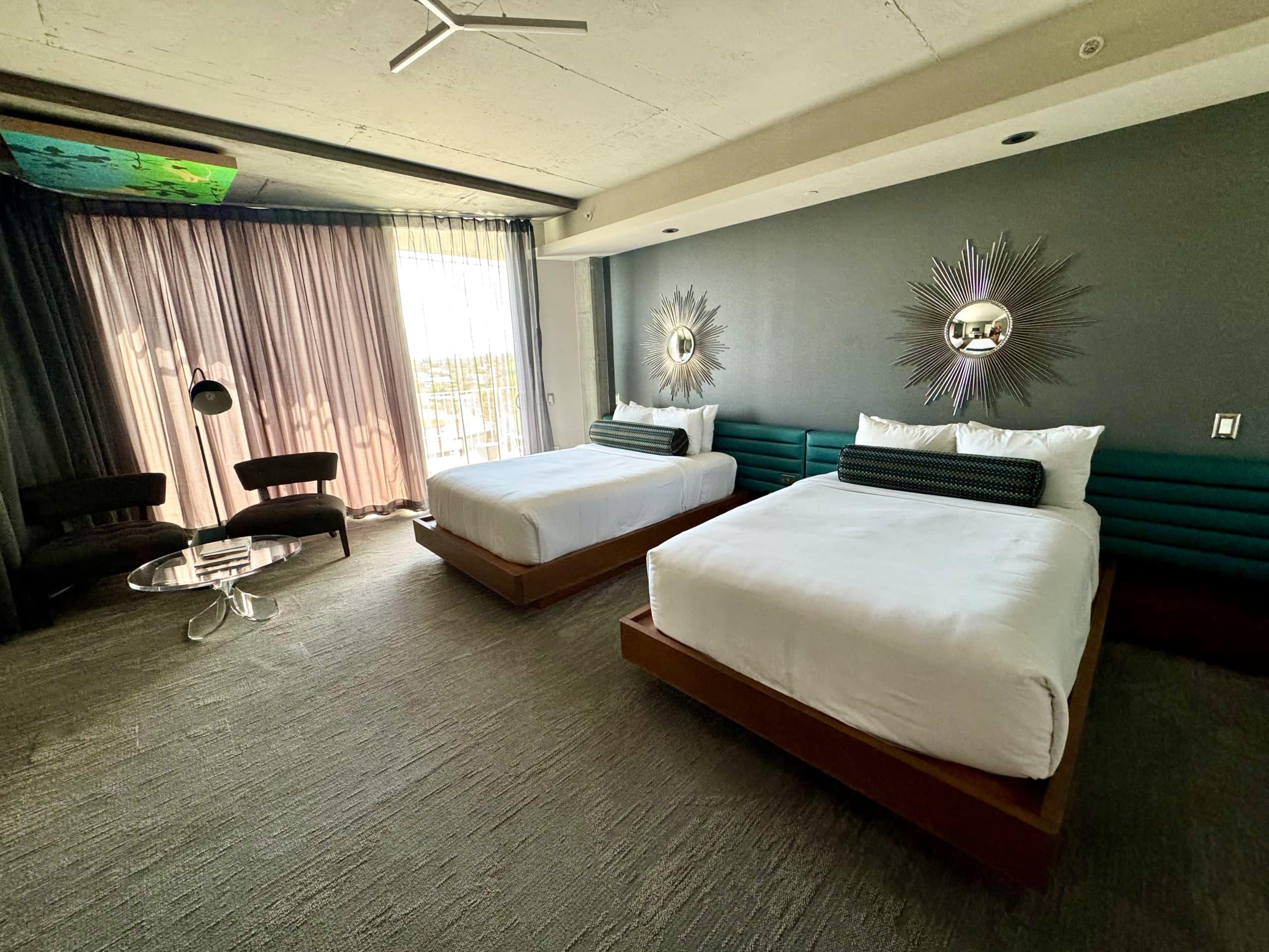 A hotel room with two queen-sized beds.