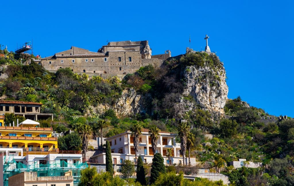 A stone castle perched above the town.
