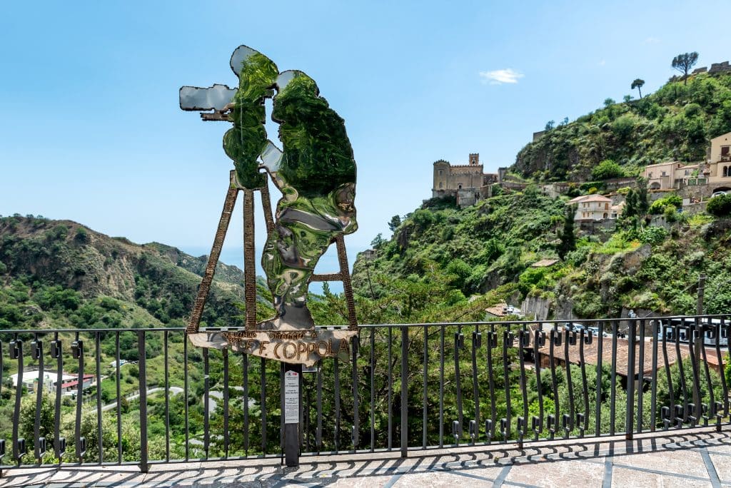 An outline of Francis Ford Coppola filming with a video camera in Sicily.