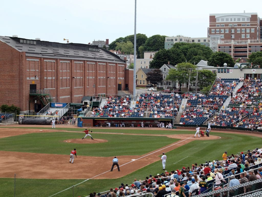 A minor-league baseball game in a small but packed stadium.