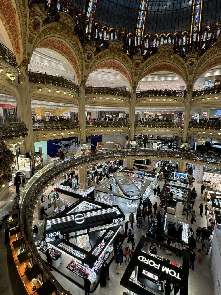 A view from a balcony in Galeries Lafayette, Paris, where each floor is crammed with clothing racks and the bottom is full of beauty brands.