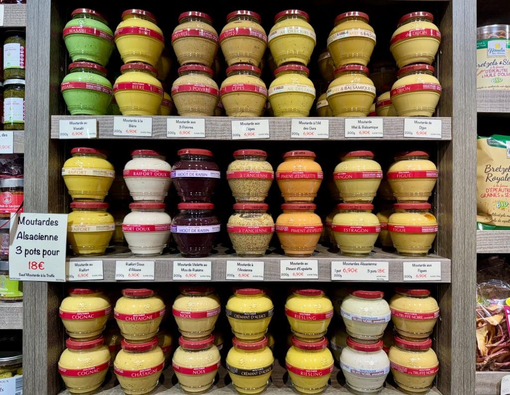 Rows of colorful mustards for sale.