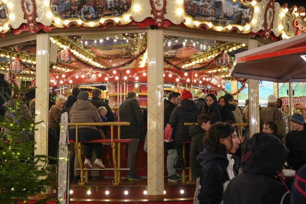 A close-up shop of people drinking on a carousel turned into a bar.