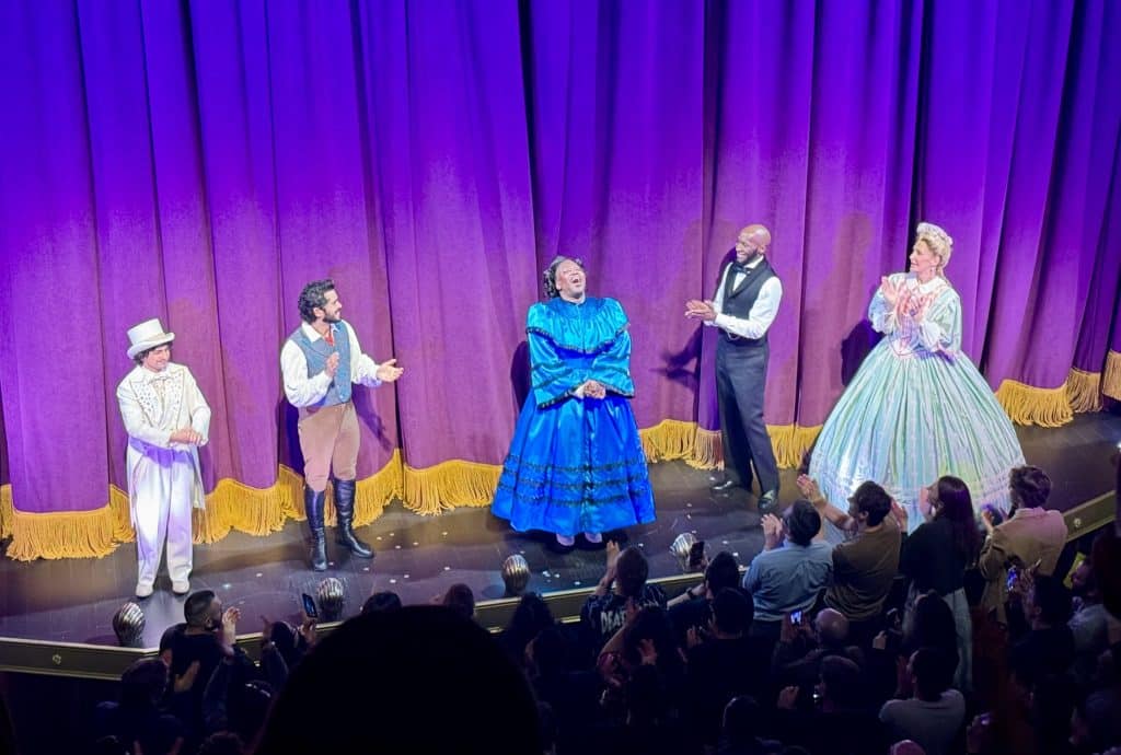 Tituss Burgess in a big blue ball gown and his Oh Mary castmates taking a bow on stage.