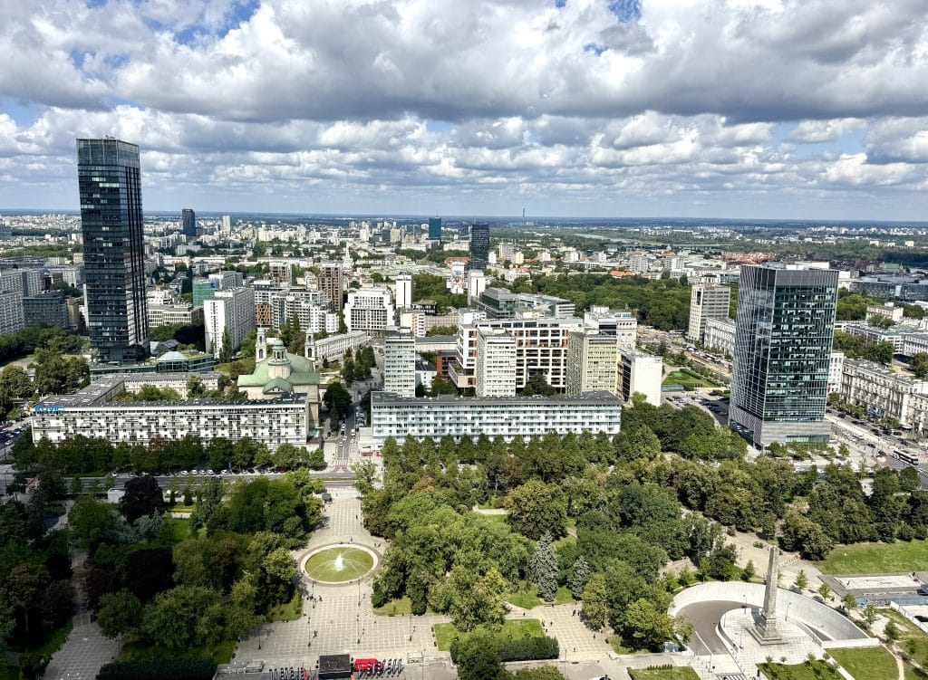 Warsaw's skyline, skyscrapers underneath a cloud-filled sky.