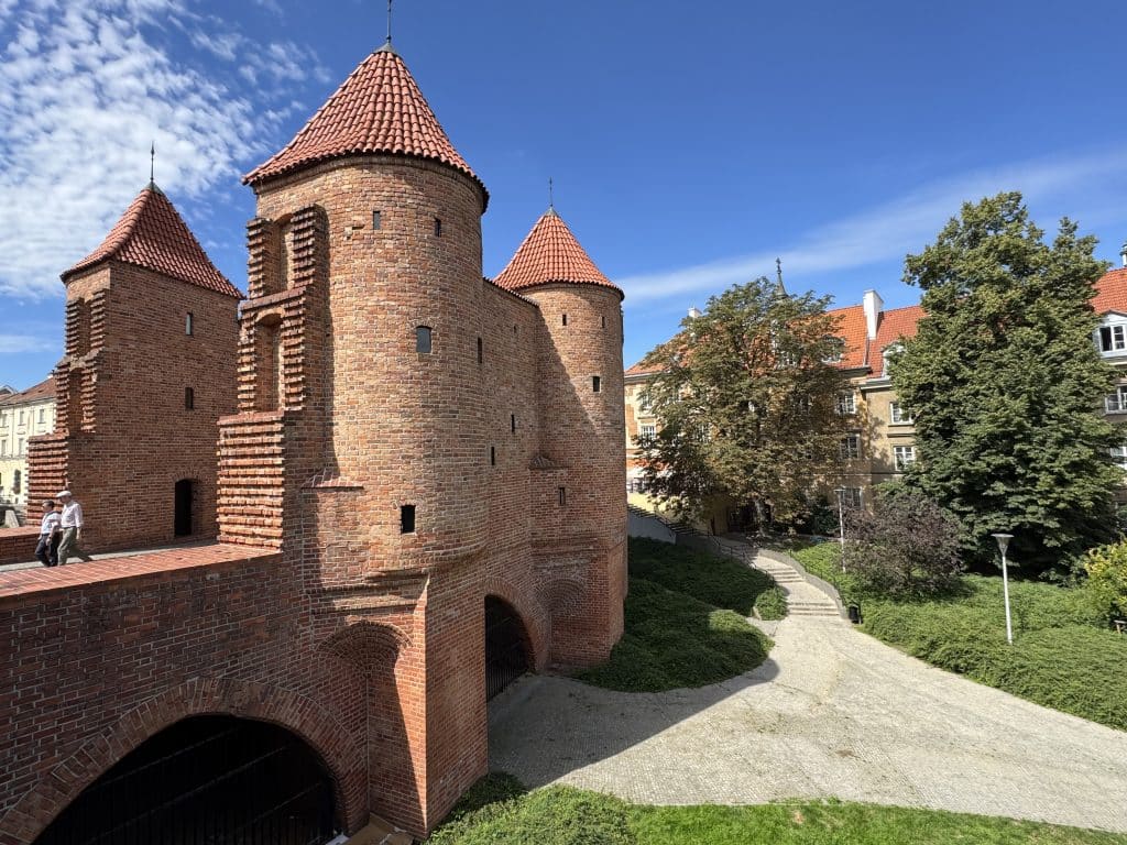 Sandstone-colored stone turrets in Warsaw's old town.
