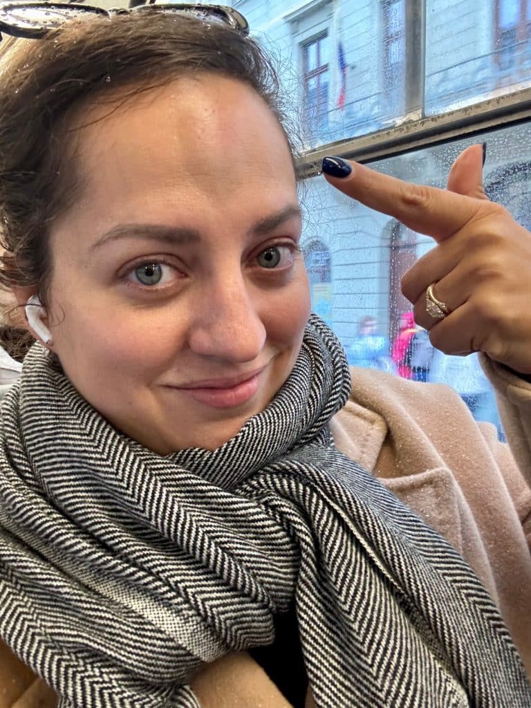 Kate pointing to her head, which has a large egg-shaped lump right in the middle of her forehead.