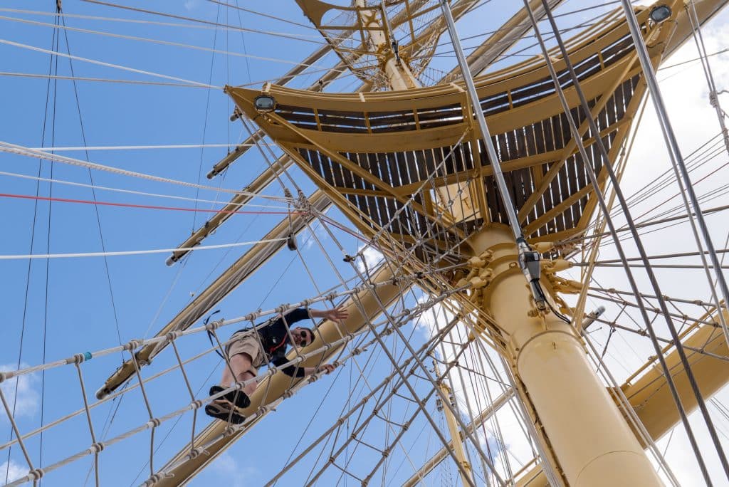 Charlie climbing the mast and almost entering the triangular crow's nest.