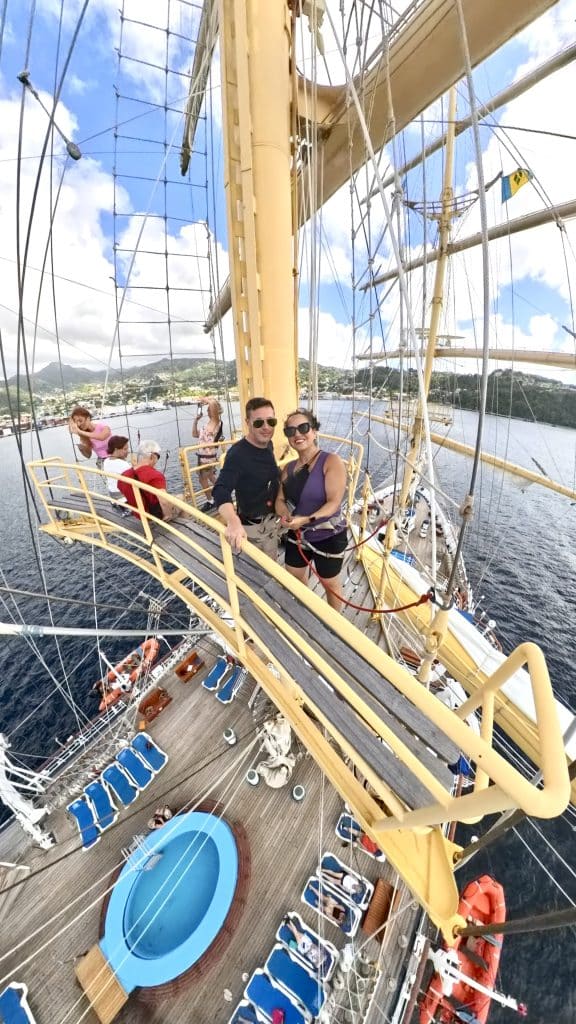 Kate and Charlie taking a selfie from the crow's nest of a tall ship.