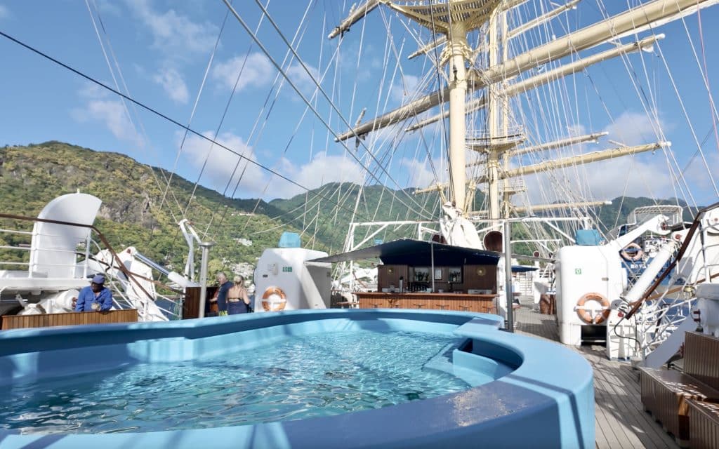 The ship's sun deck, with a swimming pool and a small bar.
