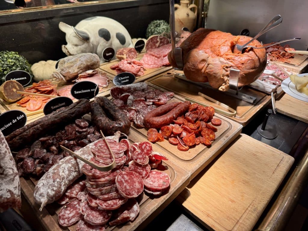 Platters full of cured sausage slices, and a large lump of nduja.