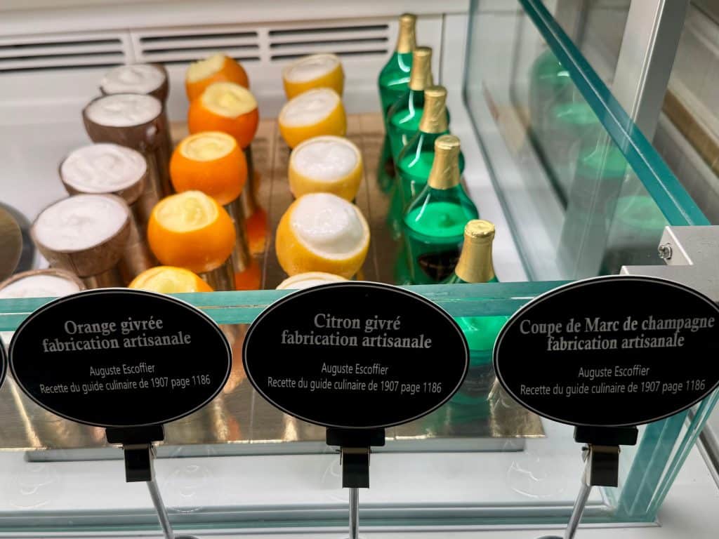 Flavored sorbets inside coconuts, oranges, lemons, and champagne bottles.