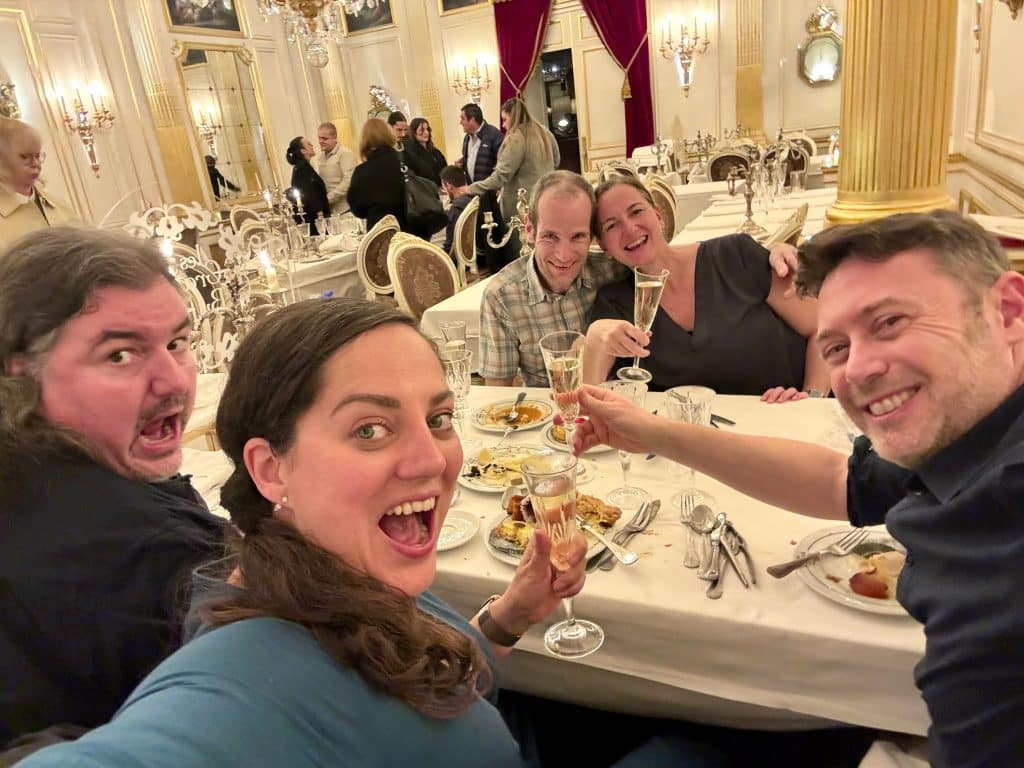 Kate and friends taking a selfie with big crazy smiles at the buffet.