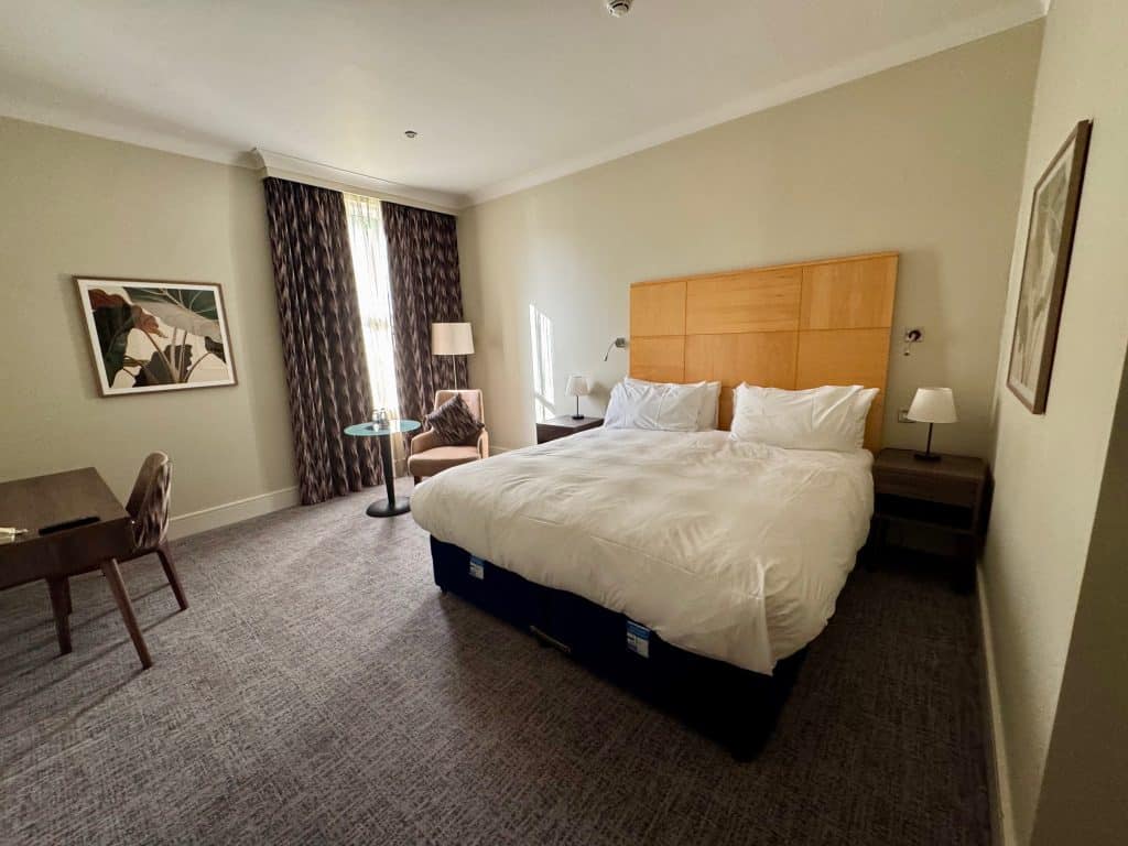 Kamar hotel dengan tempat tidur putih besar.
