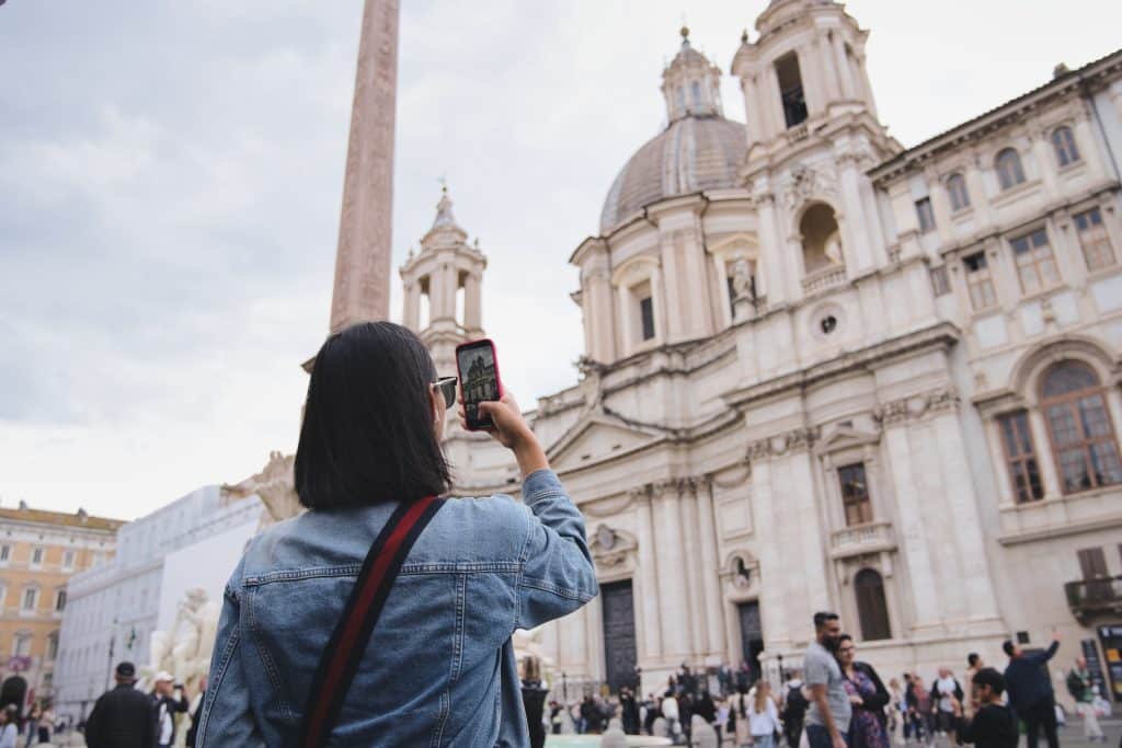 A woman photographing a cathedral in Italy.