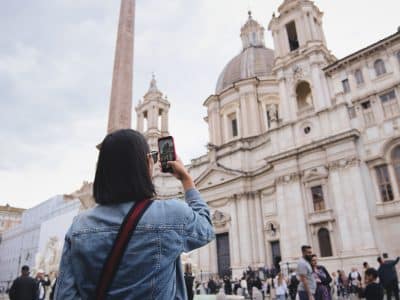 A woman photographing a cathedral in Italy.