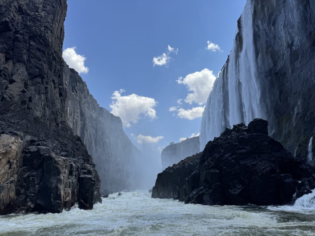 Victoria Falls, with heavy waterfalls falling, as seen from the bottom of the gorge.
